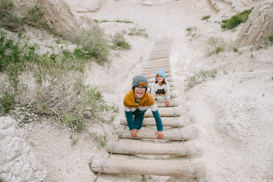 Kids climb staircase on Notch Trail hike in The Badlands National park