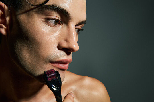 Man Using Needle Derma Roller
