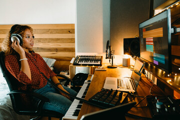 Music producer working at home studio listening to music track