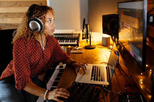 Music producer working at home studio using midi pad controller
