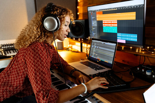 Music producer working at home studio using midi pad controller