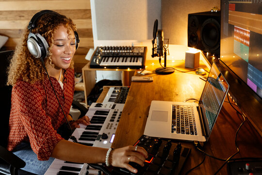 happy Music producer working at home studio using mini pad controller