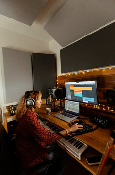 Music producer working at home studio using midi pad controller