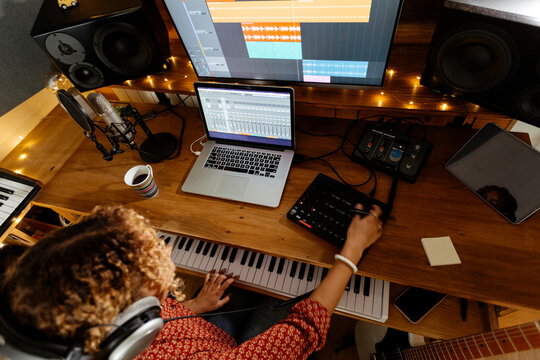 Music engineer working at home studio using midi pad controller