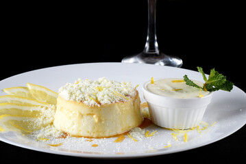 Delicious condensed milk and coconut pudding on a white plate - Coconut pudding with eggs sprinkled with powdered milk