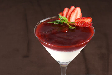 Traditional italian dessert tiramisu in a glass. sprinkle the cocoa powder over the tiramisu. pours cocoa cream powder condensed milk chocolate and berries
