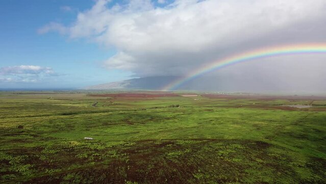 2022 - Excellent aerial footage of half of rainbow over a field in Maui.