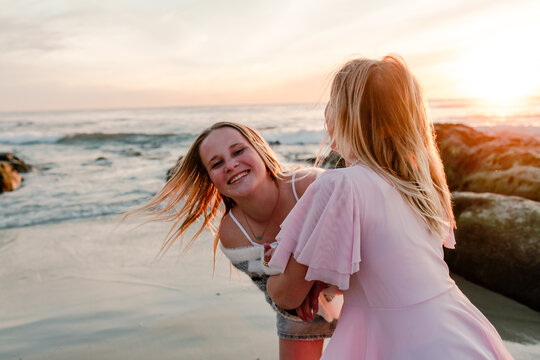 Laughing teenage sisters outdoors together