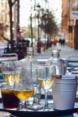 Close-up view of a partially consumed drink tray on a customer table in the street