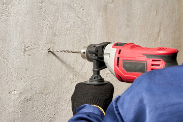 Drilling a hole in the wall with a drill