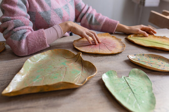 human hands and plates in the form of leaves