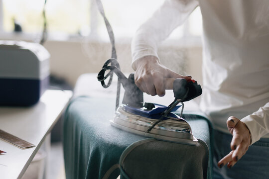 Smoothing iron. Hot steam. Garment manufacture. Atelier