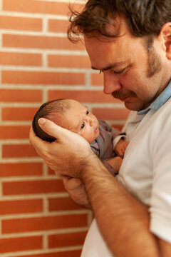 Excited dad with baby in arms