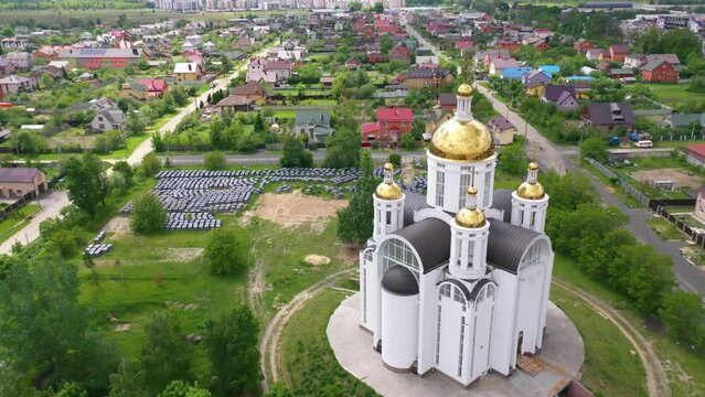 2022 - aerial of the Church of St. Andrew Pervozvannoho All Saints in Bucha, Ukraine where dozens of unmarked graves and war crimes victims were unearthed.