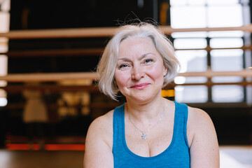 Rest after training. Boomer sportswoman. Gym hall. Happy retirement