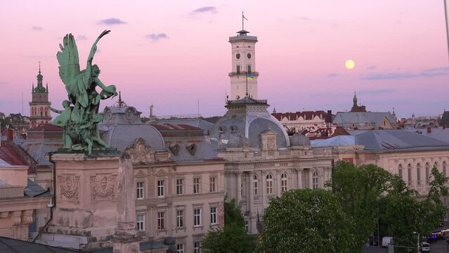 2022 - beautiful full moonrise over the opera house and classical buildings in central Lviv, Ukraine.