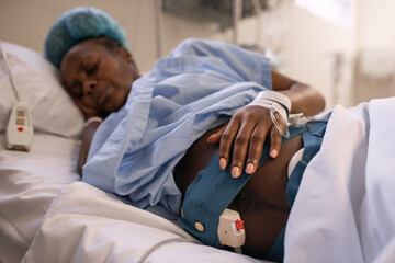 Pregnant African female touching CTG belt