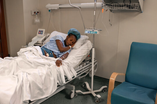 Tired pregnant woman on hospital bed