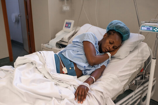 Weary pregnant female sleeping in labor room