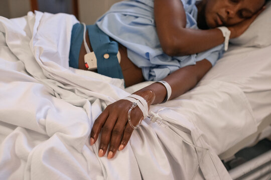 Sleeping pregnant woman with IV tube