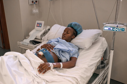 Pregnant woman with fetal monitor on belly