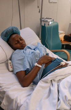 Pregnant African woman near nurse call button