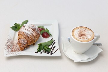 cup of coffee with croissant