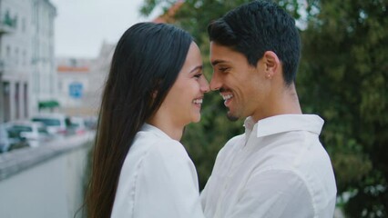 Laughing lovers bonding at park close up. Latina playful pair touching foreheads