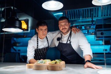 Men in restaurant kitchen at night