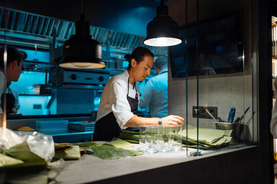Asian chef preparing banana leaves
