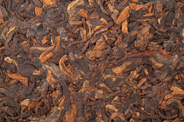 A piece of chinese tea shu puer isolated on white background. Texture fermented traditional compressed tea.