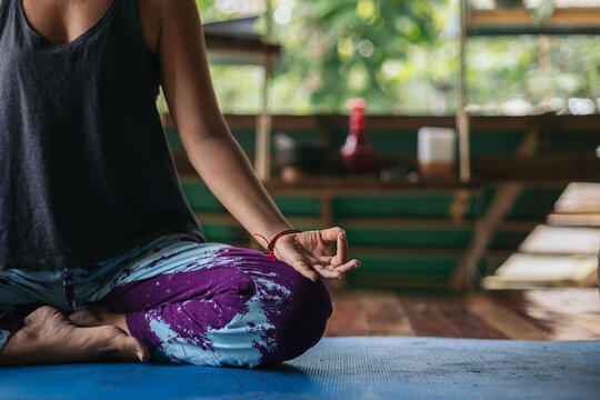 Cutout of a woman meditating in lotus pose