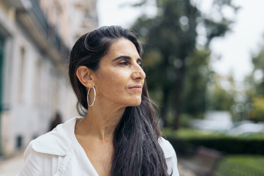 Close-up of a beautiful middle-aged woman keeping young