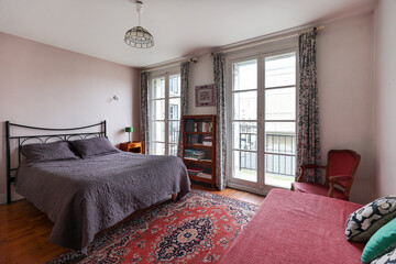 Vintage bedroom with classic french wood furniture and two windows