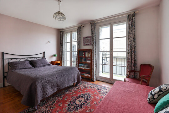 Vintage bedroom with classic french wood furniture and two windows