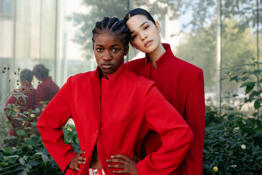 Woman leaning on head of black girlfriend