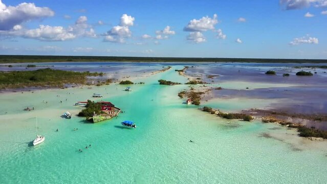 Bacalar,Quintana Roo, Mexico-Nov.27th 2017: drone view descent over the canal de los piratas of Bacalar Lagoon of 7 colors with blue turquoise waters, blue sky and white clouds