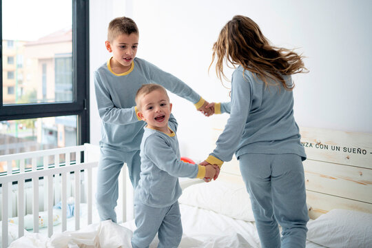 Kids Playing In Bed