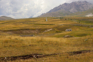 View of a mountain landscape with meadow, trees, and steppe in Abruzzo in summer in Italy