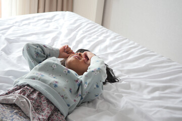 a upset child girl cover her face with hand 