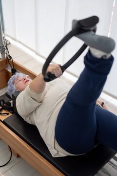 Woman doing exercise with Pilates ring