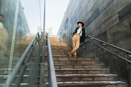 Stylish woman with hat in a stairs