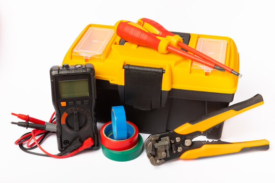 Tool Box Isolated On White Background. Electrician's Tool Box On A White Background. Multimeter, Screwdrivers, Electrical Tape And Pliers. Electrician Concept. Business And Profession.