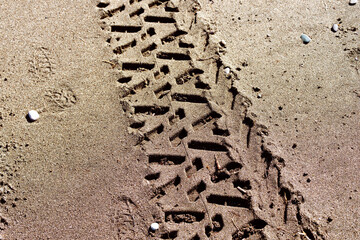 Tire track in the sand, closeup 
