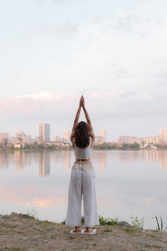 Woman practicing yoga standing on nails