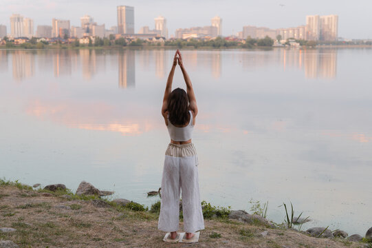 Woman practicing yoga standing on nails