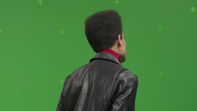 CHROMA KEY Portrait of 20s African-American male student pretending he is visiting art exhibition against green screen