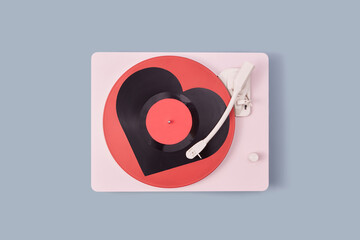 Vinyl turntable with red heart-shaped plate.