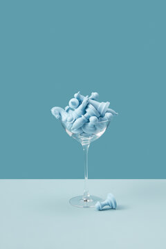 Cocktail glass full of blue chess pieces.