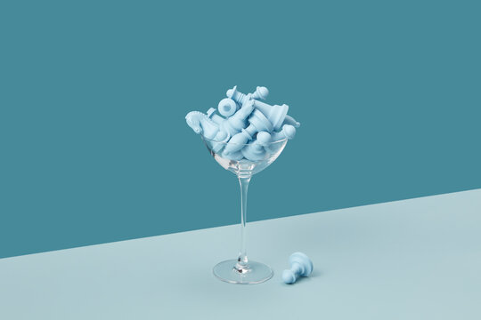 Blue chess figures in elegant cocktail glass.